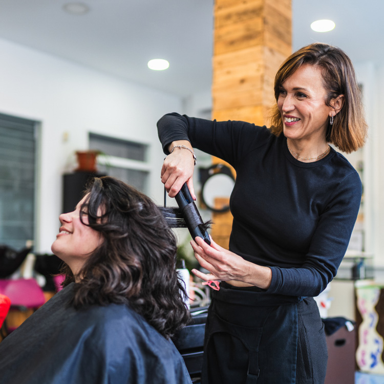 Local hairdresser doing a clients hair