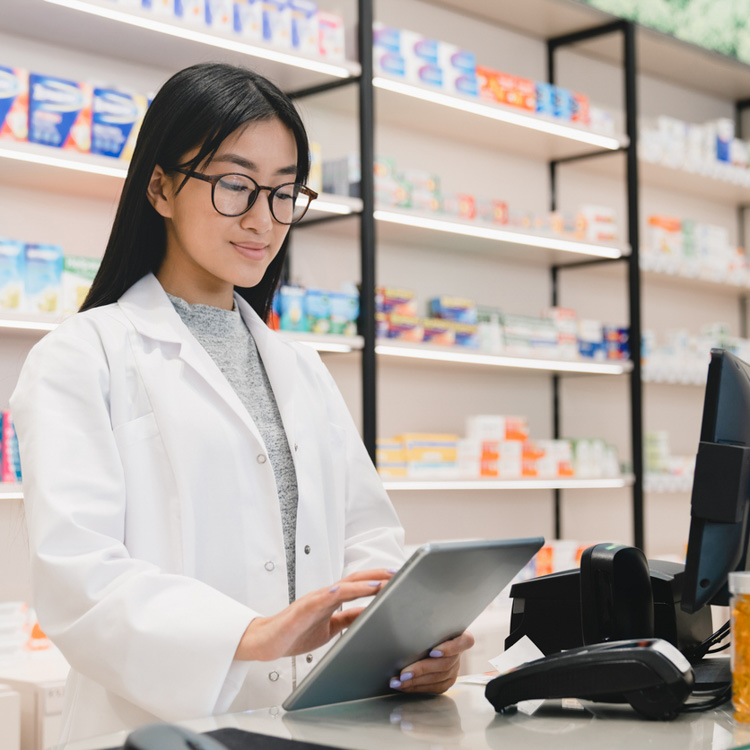 Pharmacist looking at marketing training provided by digital marketing specialist 