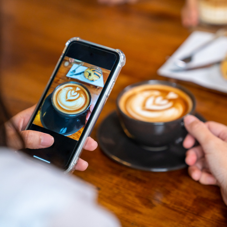 Social media manager getting content at a local cafe
