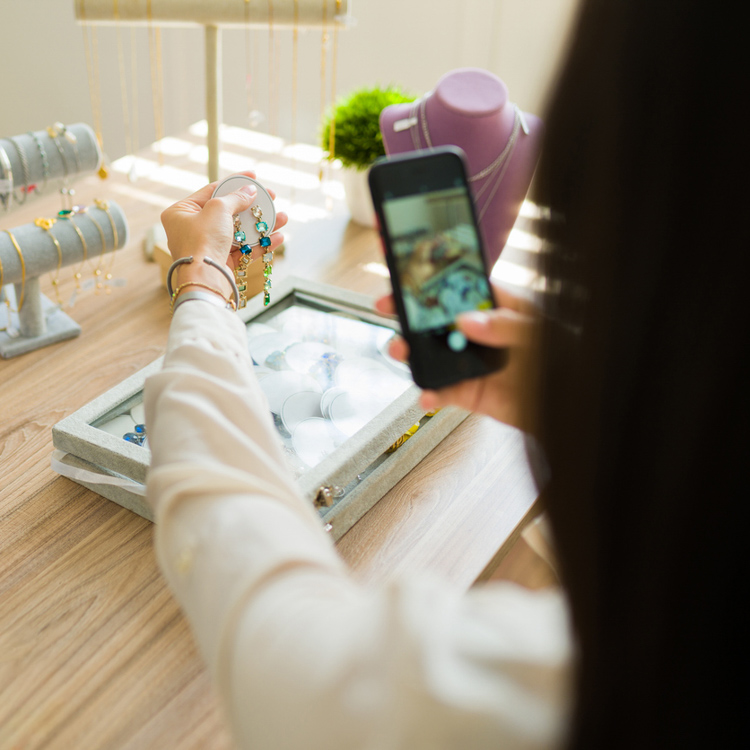 social media manager taking photo of jewellery for business social media